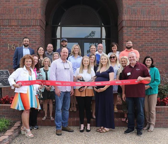 chamber members attend a ribbon cutting for a new business