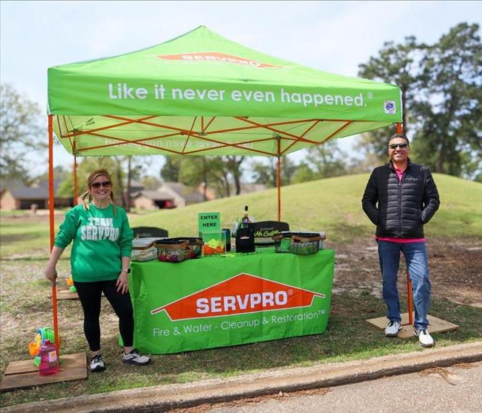 SERVPRO employees in front of SERVPRO tent