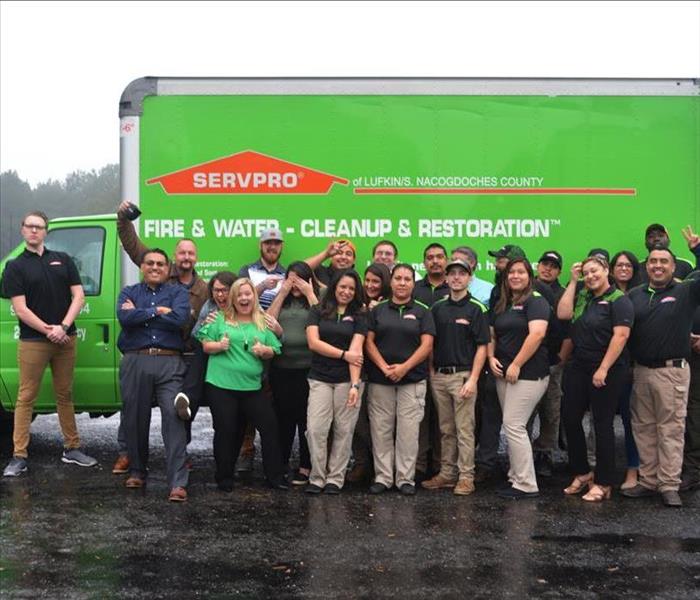 A group of SERVPRO employees posing in front of a SERVPRO truck