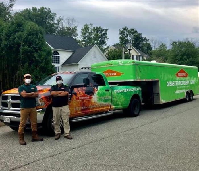 SERVPRO Employees standing in front of a SERVPRO Vehicle.