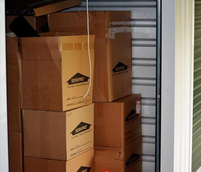 A group of SERVPRO boxes sitting inside a storage unit.