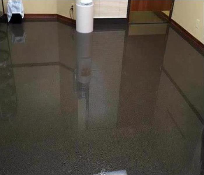 A flooded floor in a large room.
