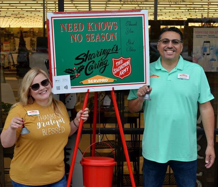 Two people ringing a bell for the salvation army.