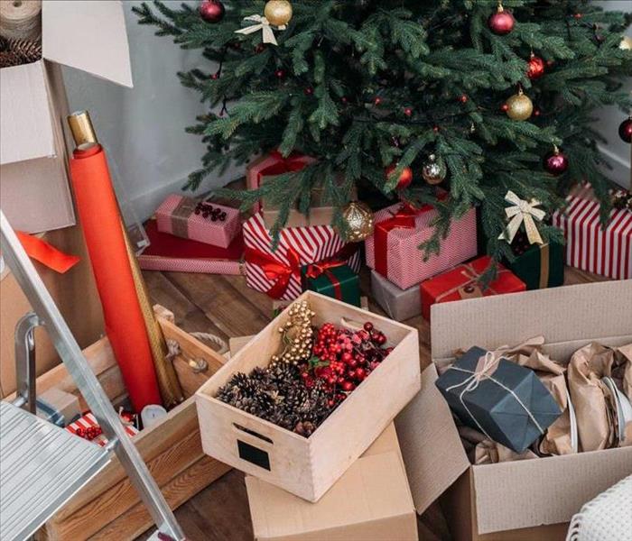 Christmas decor in boxes and cleaning happening around them.