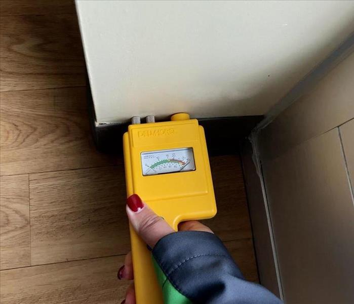servpro employee using a moisture meter