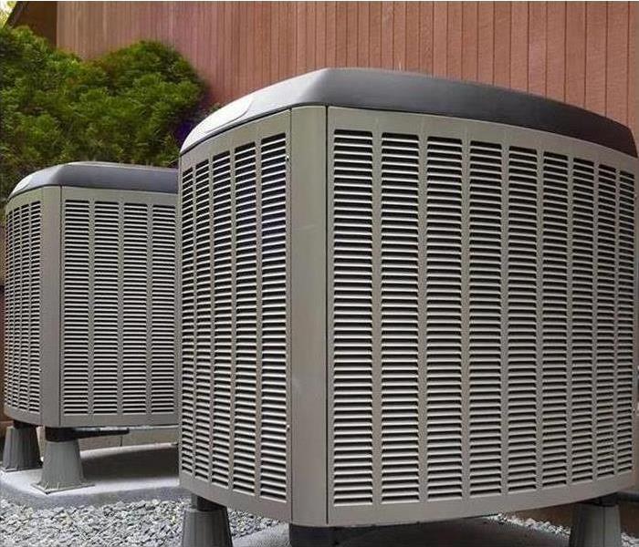Two air conditioner units outside.